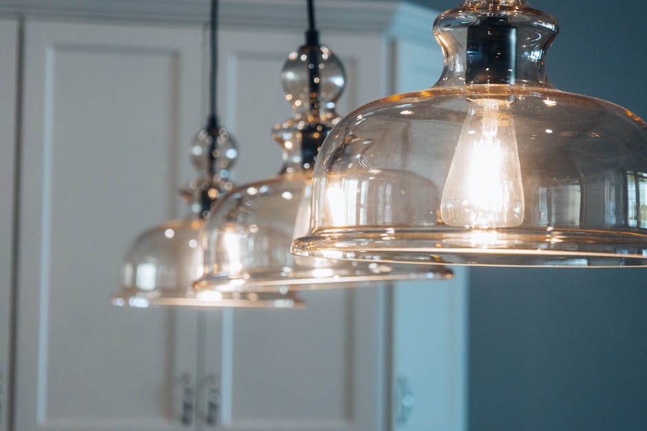 Kitchen light flickering fixture inspection: detailed view of modern hanging pendant lights with exposed bulbs over a kitchen counter, the kind of fixture where a kitchen light flickering complaint commonly starts after a recent LED bulb swap