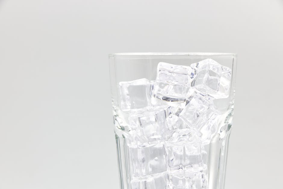 Ice maker not working: a clear glass filled with crescent ice cubes on a clean background, showing the healthy output you should see once the ice maker not working fault is fixed