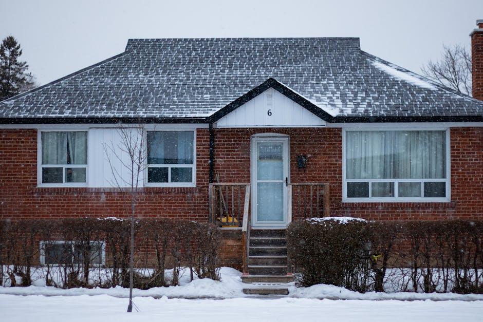 Heat pump not heating winter context: suburban brick house in Toronto covered with snow on a winter day, the typical environment where a heat pump not heating becomes a same-day problem