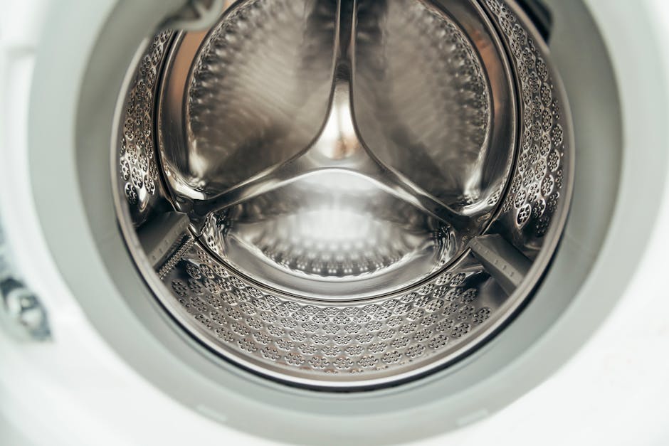 Washer not draining - close-up of a clean stainless steel washing machine drum interior