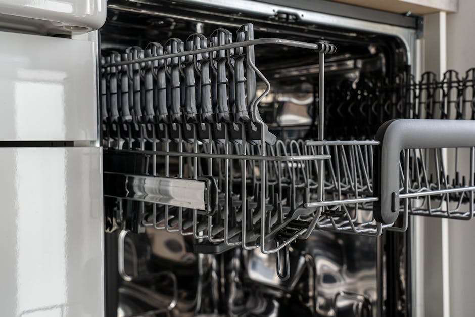 Dishwasher not cleaning rack inspection: detailed view of an empty modern dishwasher rack with stainless steel construction, the layout you need to evaluate when troubleshooting a dishwasher not cleaning problem