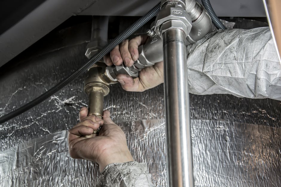 Plumber working on hot water supply pipes related to water heater no hot water diagnostics
