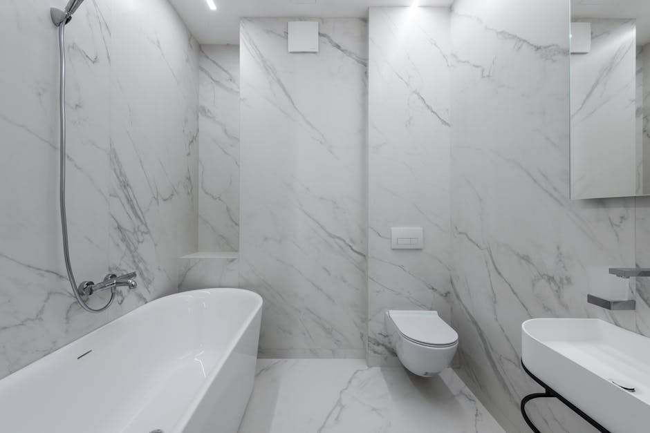 Toilet won't flush context: stylish bathroom interior with marble walls, a white bathtub placed near the toilet and ceramic sink, illustrating the typical setting for a toilet won't flush homeowner diagnosis
