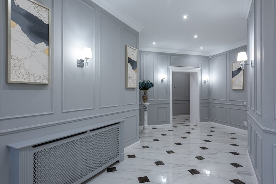 Light switch not working context: contemporary villa hallway with shiny tiled floor, gray walls, and decorative lamps, the typical environment where a light switch not working complaint lives