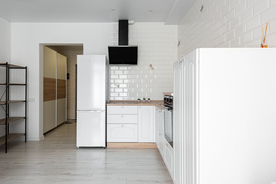 Refrigerator not cooling in a contemporary kitchen with white brick wall - pull the unit out to access coils