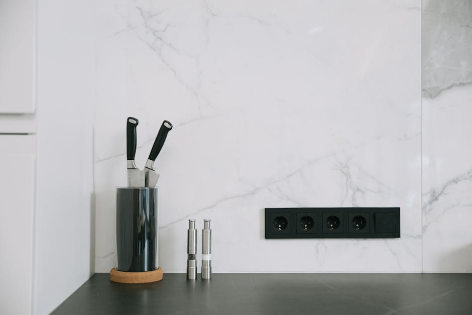 GFCI keeps tripping kitchen context: modern kitchen with marble backsplash, knife holder, and power outlets, the typical layout where a GFCI keeps tripping under appliance load