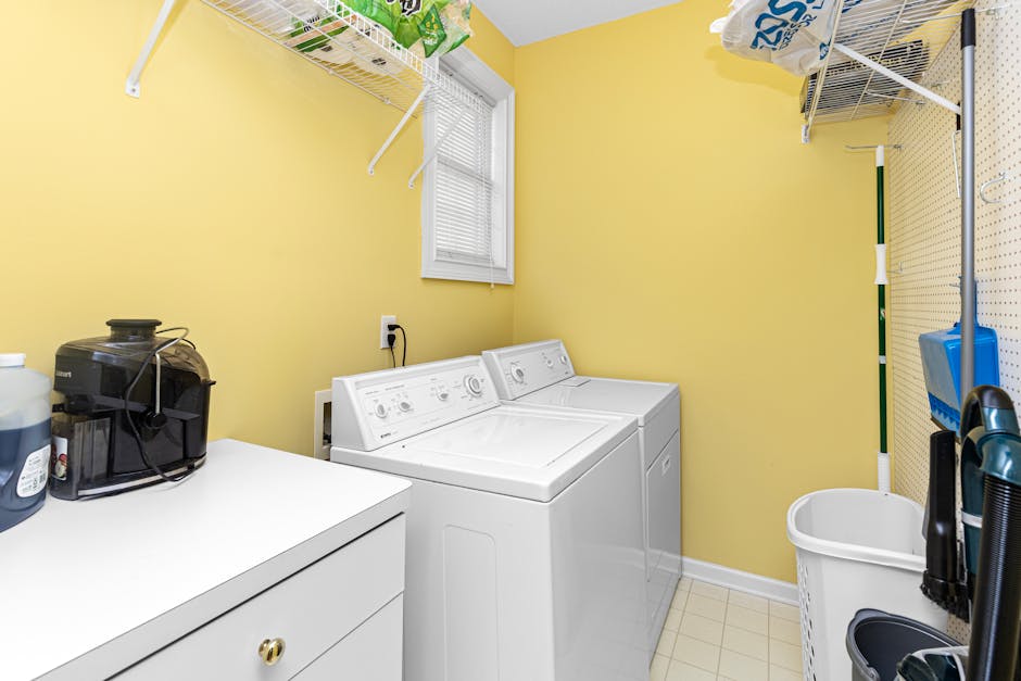 Dryer takes too long: spacious bright laundry room with stacked washer and dryer and open shelves, the typical setup where a dryer takes too long under-the-radar fault hides