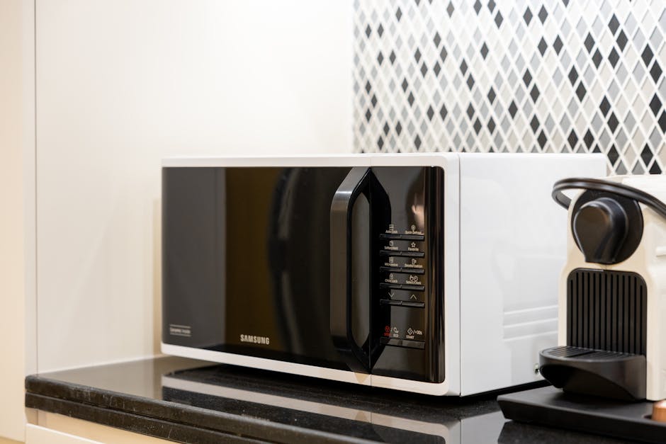 Microwave not heating: stylish kitchen counter featuring a black countertop microwave and coffee maker in a modern home setting