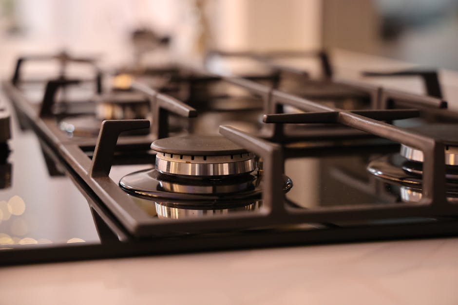 Stove burner won't light: close-up of a modern stainless steel gas stove top, the classic homeowner setup for a stove burner won't light diagnosis