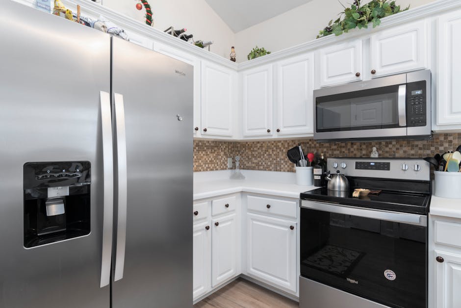 Ice maker not working: contemporary kitchen interior featuring a modern stainless steel refrigerator with built-in ice maker as the typical homeowner setup for this fix