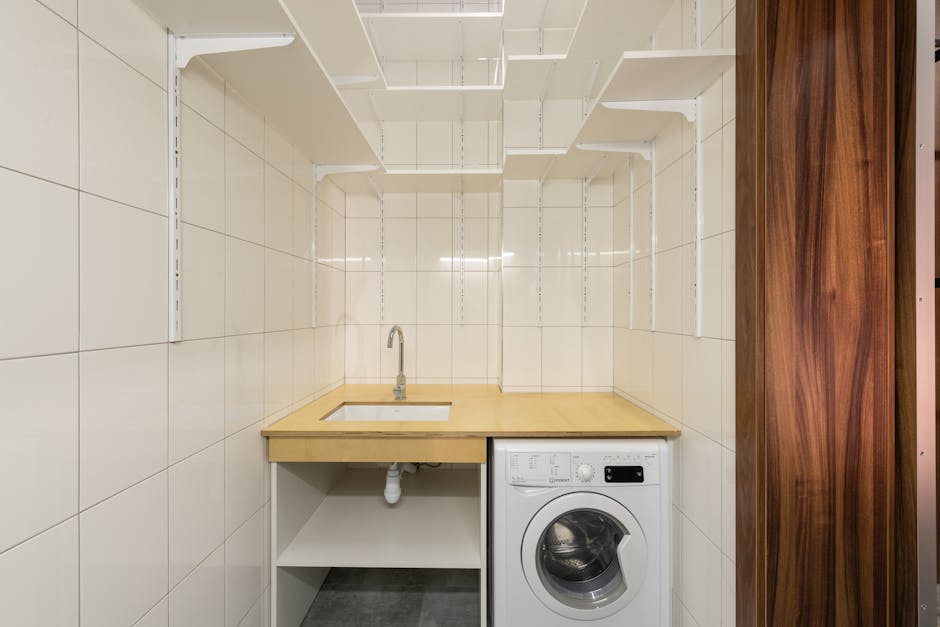 Dryer not spinning: a clean minimalist laundry room with a front-loading dryer and washer side by side, the typical setup before a dryer not spinning diagnosis