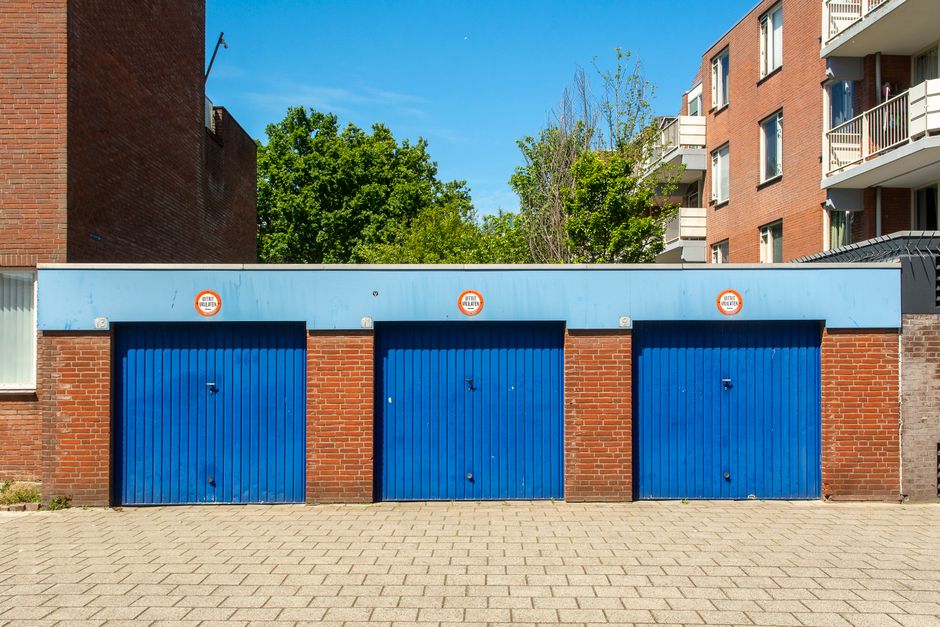 Three residential doors on a brick home illustrating typical garage door replacement cost