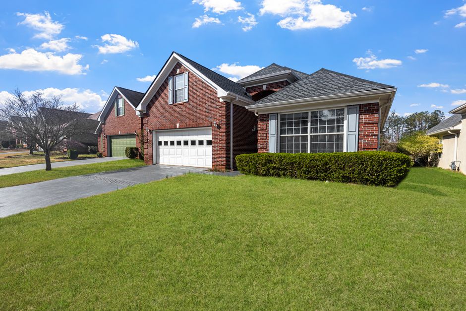 Suburban brick home with roofline gutters that determine gutter replacement cost